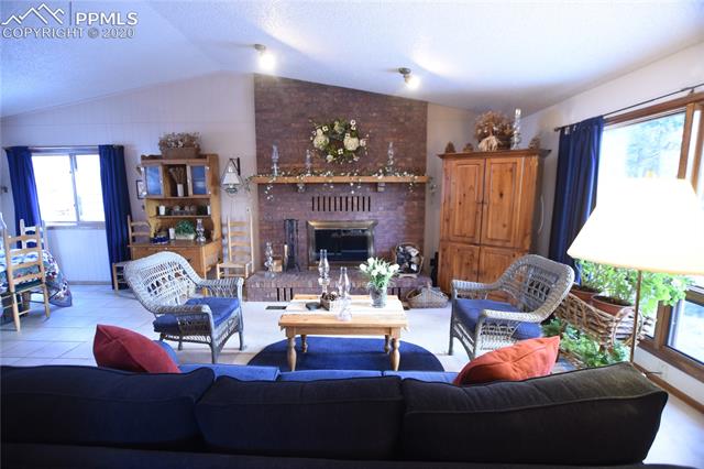 1161 Pine Ridge Road Woodland Park, CO 80863 - Photo 4 of 40 Living Room on Main Floor Open to Dining Room and Kitchen