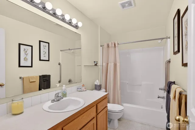 a bathroom with a sink toilet tub and shower