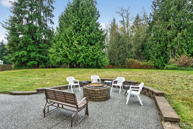 a view of a patio with lawn chairs and a yard