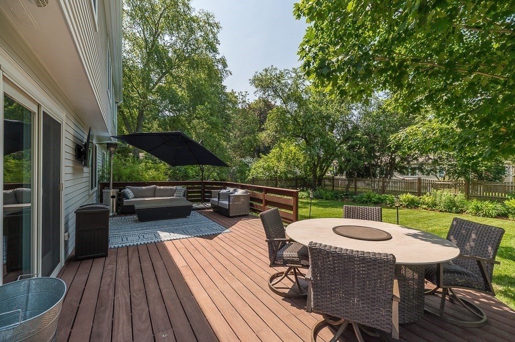 31 Orchard Road Hamilton, MA 01982 - Photo 37 of 41 a view of a patio with table and chairs potted plants with wooden floor and fence