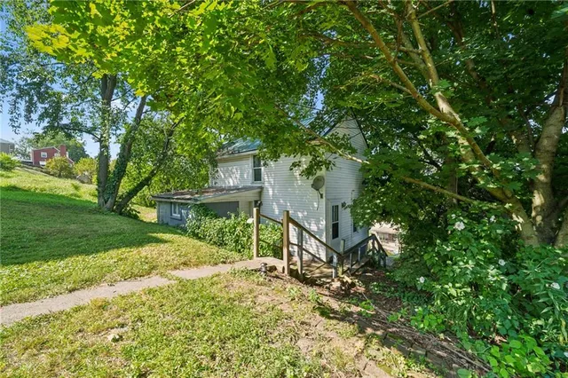 a view of a house with a tree in a yard