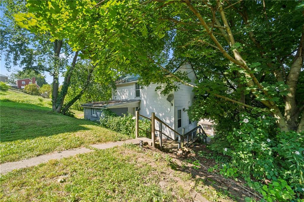 311 Lowell Street Vandergrift, PA 15690 - Photo 23 of 25 a view of a house with a tree in a yard
