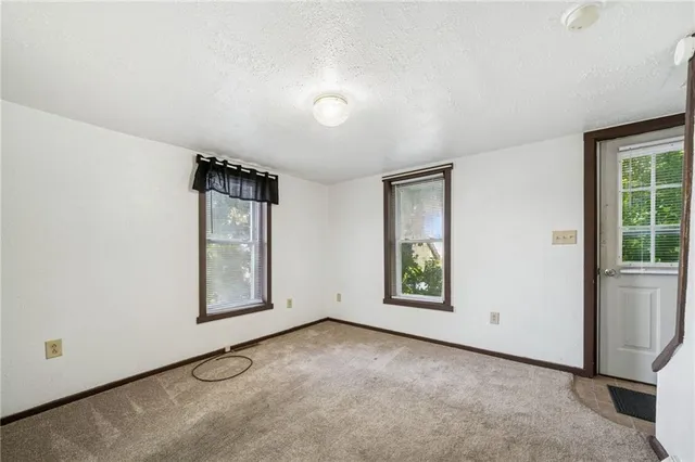 an empty room with windows and closet