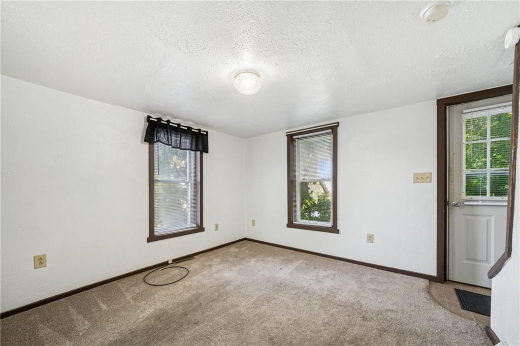 311 Lowell Street Vandergrift, PA 15690 - Photo 4 of 25 an empty room with windows and closet