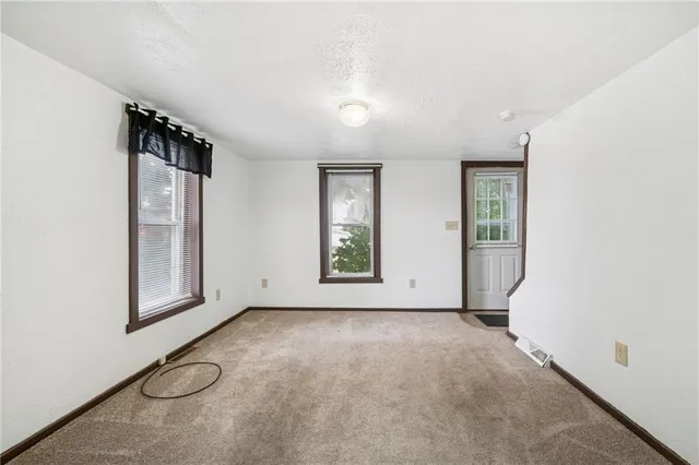 an empty room with windows and closet