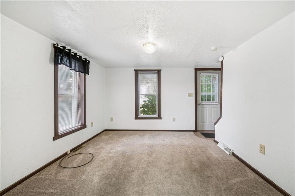 311 Lowell Street Vandergrift, PA 15690 - Photo 5 of 25 an empty room with windows and closet