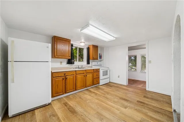 a kitchen with stainless steel appliances granite countertop a refrigerator and a sink