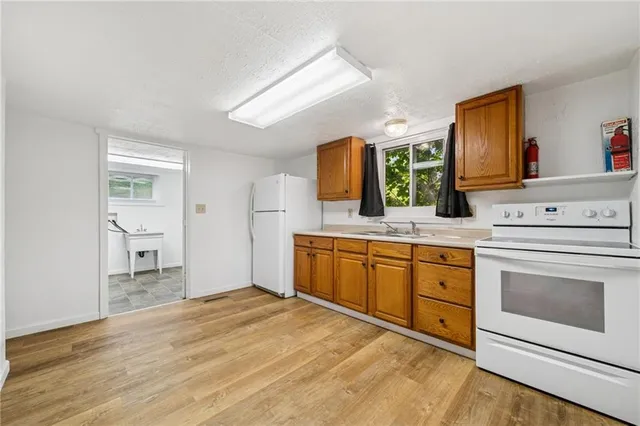 a spacious bathroom with a granite countertop sink and a mirror