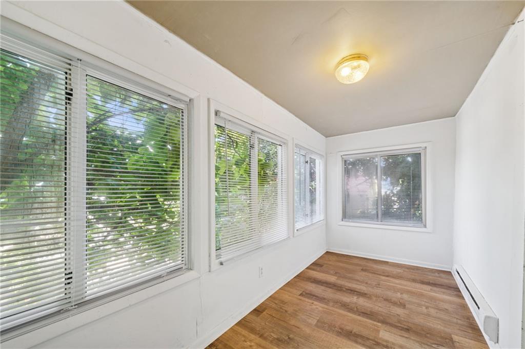 311 Lowell Street Vandergrift, PA 15690 - Photo 10 of 25 a view of an empty room with wooden floor and a window