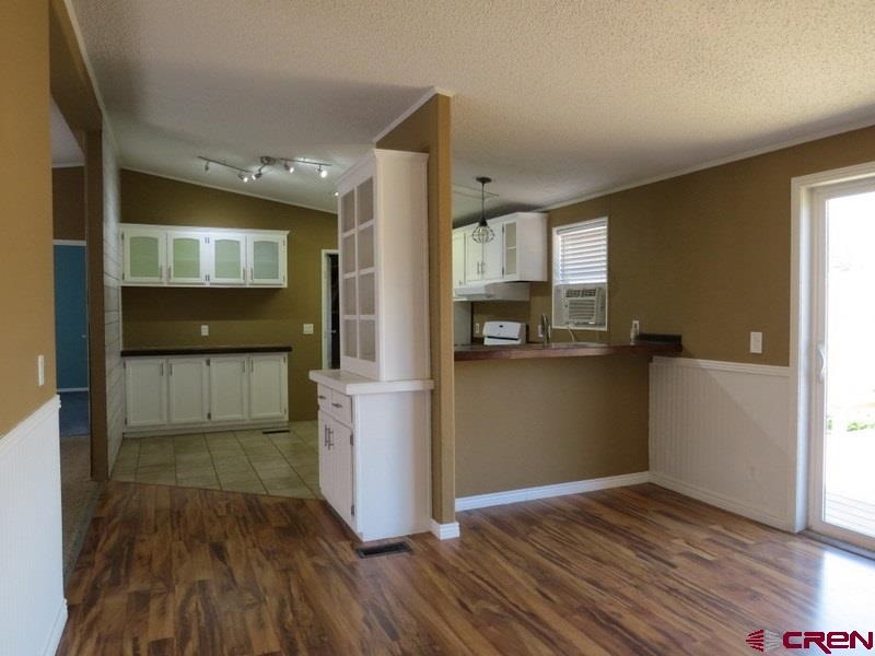 19776 Ward Creek Road Cedaredge, CO 81413 - Photo 6 of 25 a view of empty room with kitchen and window