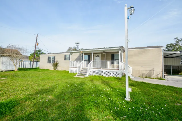 a house view with a sitting space and garden