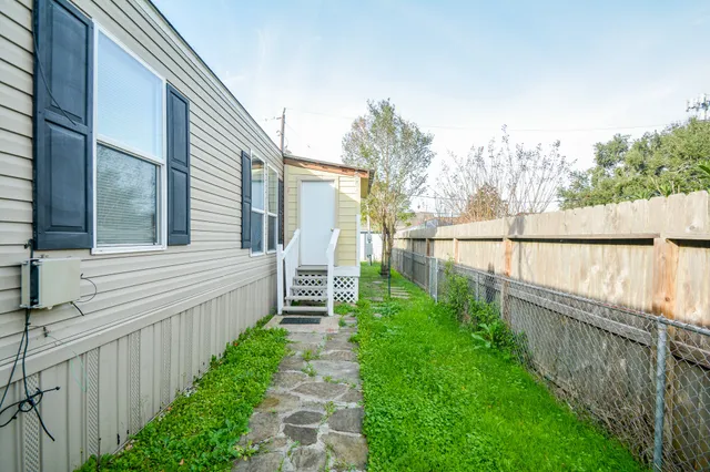 a view of a garden with wooden fence
