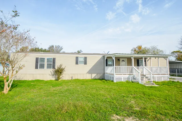 a front view of house with yard and seating area