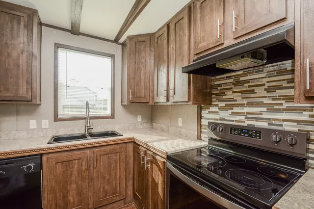 a kitchen with wooden cabinets and a stove top oven