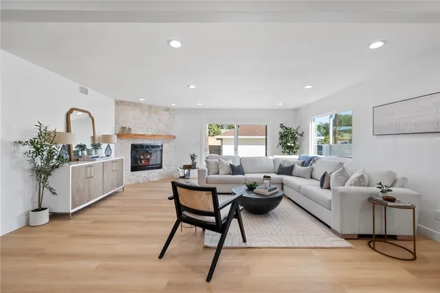 a living room with furniture and a fireplace