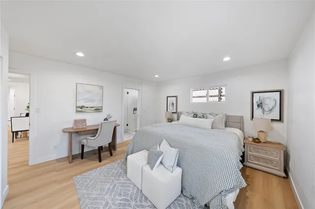 a bedroom with furniture and a wooden floor