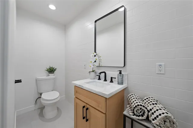 a bathroom with a toilet a sink and a mirror