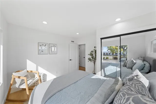 a bedroom with a large bed and a window