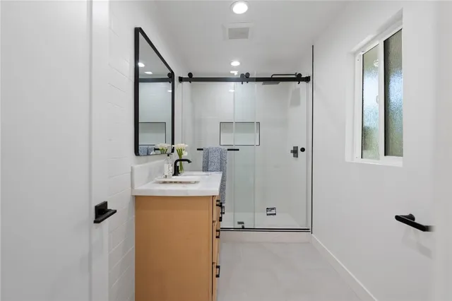a bathroom with a sink mirror toilet and shower