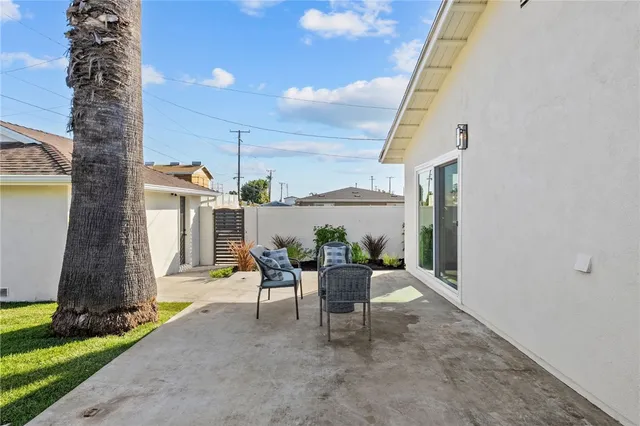 a view of a patio with table and chairs