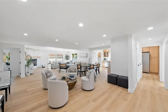a living room with lots of furniture and kitchen view