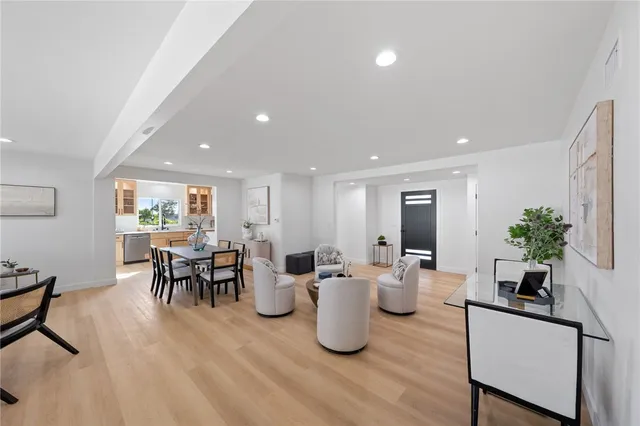 a dining room with furniture and a potted plant