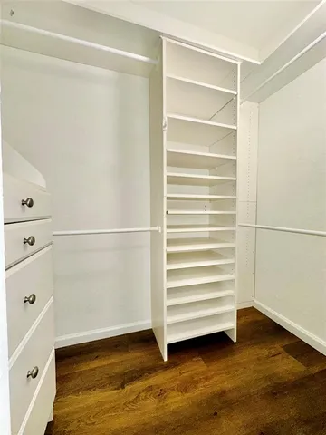 a view of walk in closet with empty racks