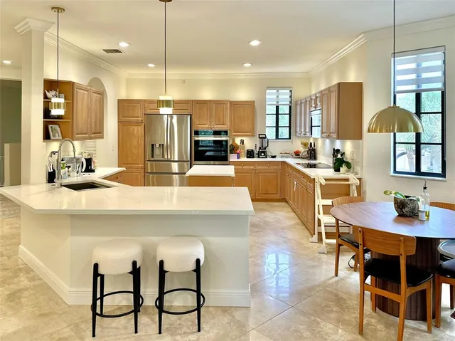 a kitchen with kitchen island granite countertop a table and chairs