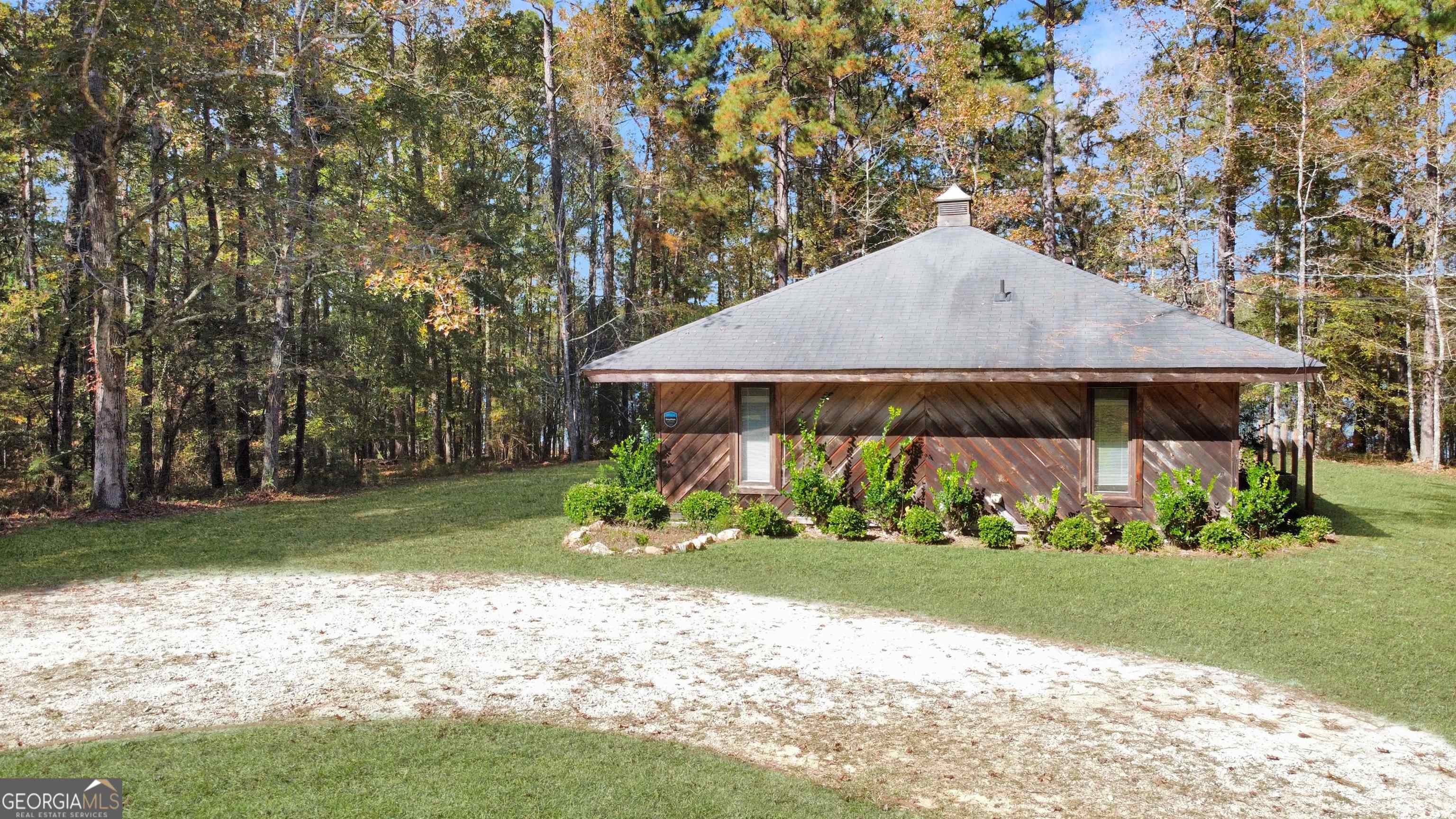 a view of a house with a yard and sitting area