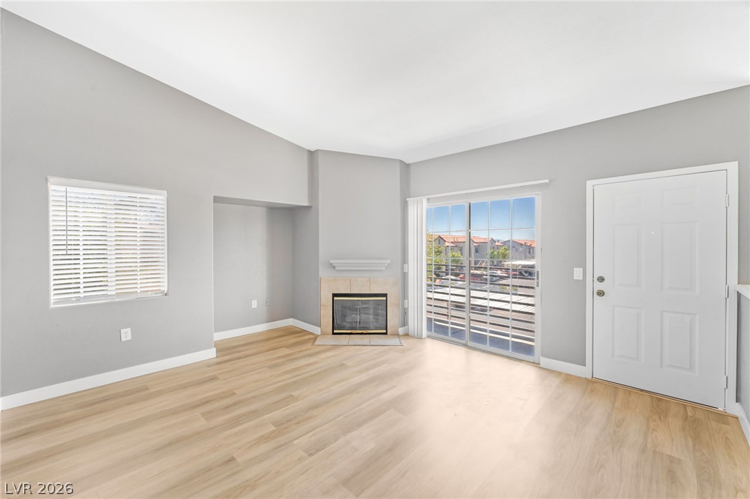 3318 North Decatur Boulevard, Unit 2152 Las Vegas, NV 89130 - Photo 8 of 58 A cozy living space features warm hardwood floors and a charming fireplace, perfect for relaxation.