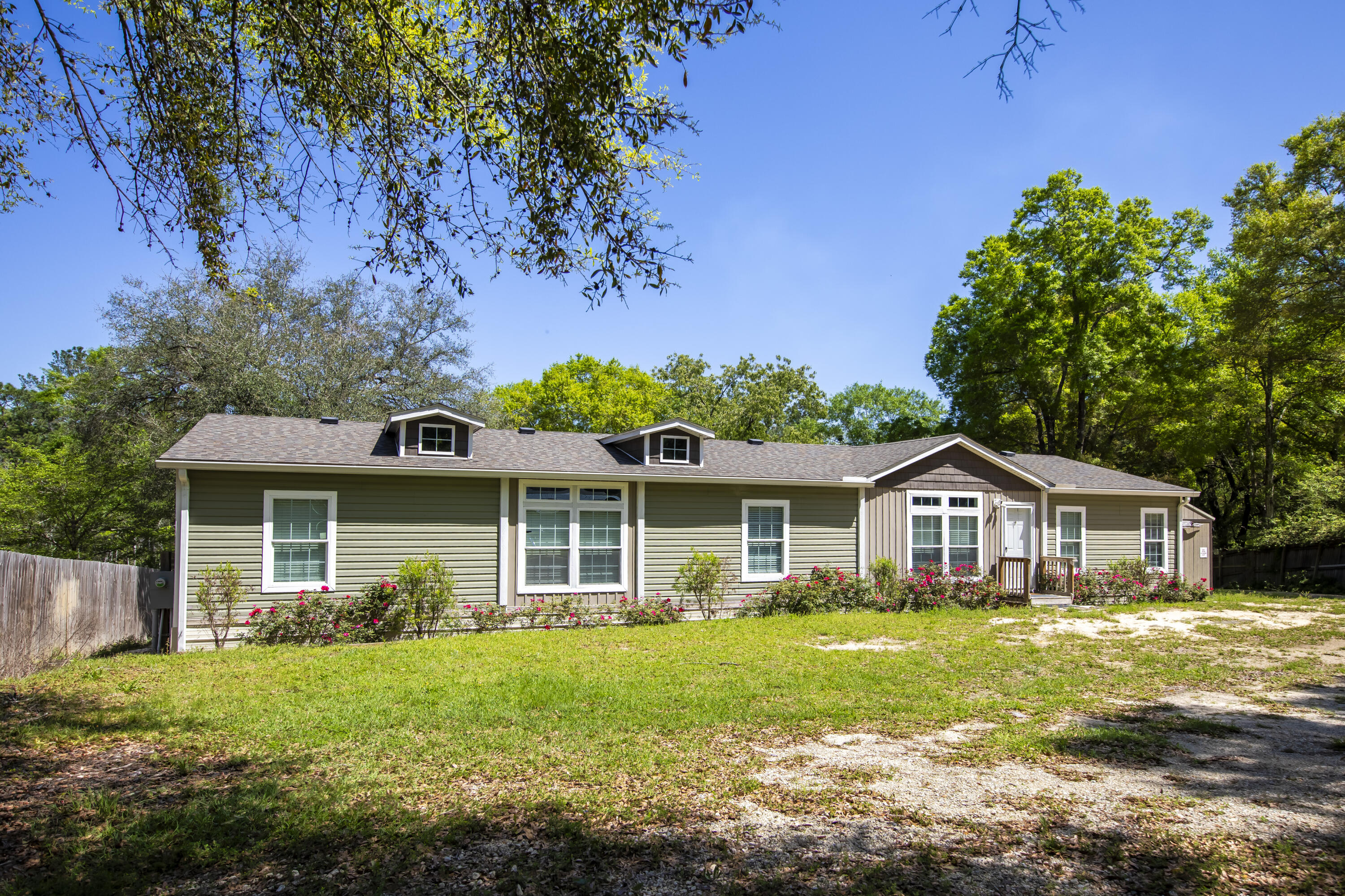 a front view of house with yard and green space