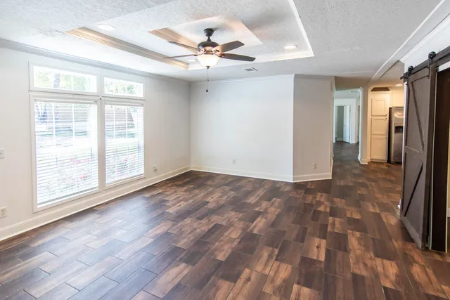 wooden floor in an empty room with a window