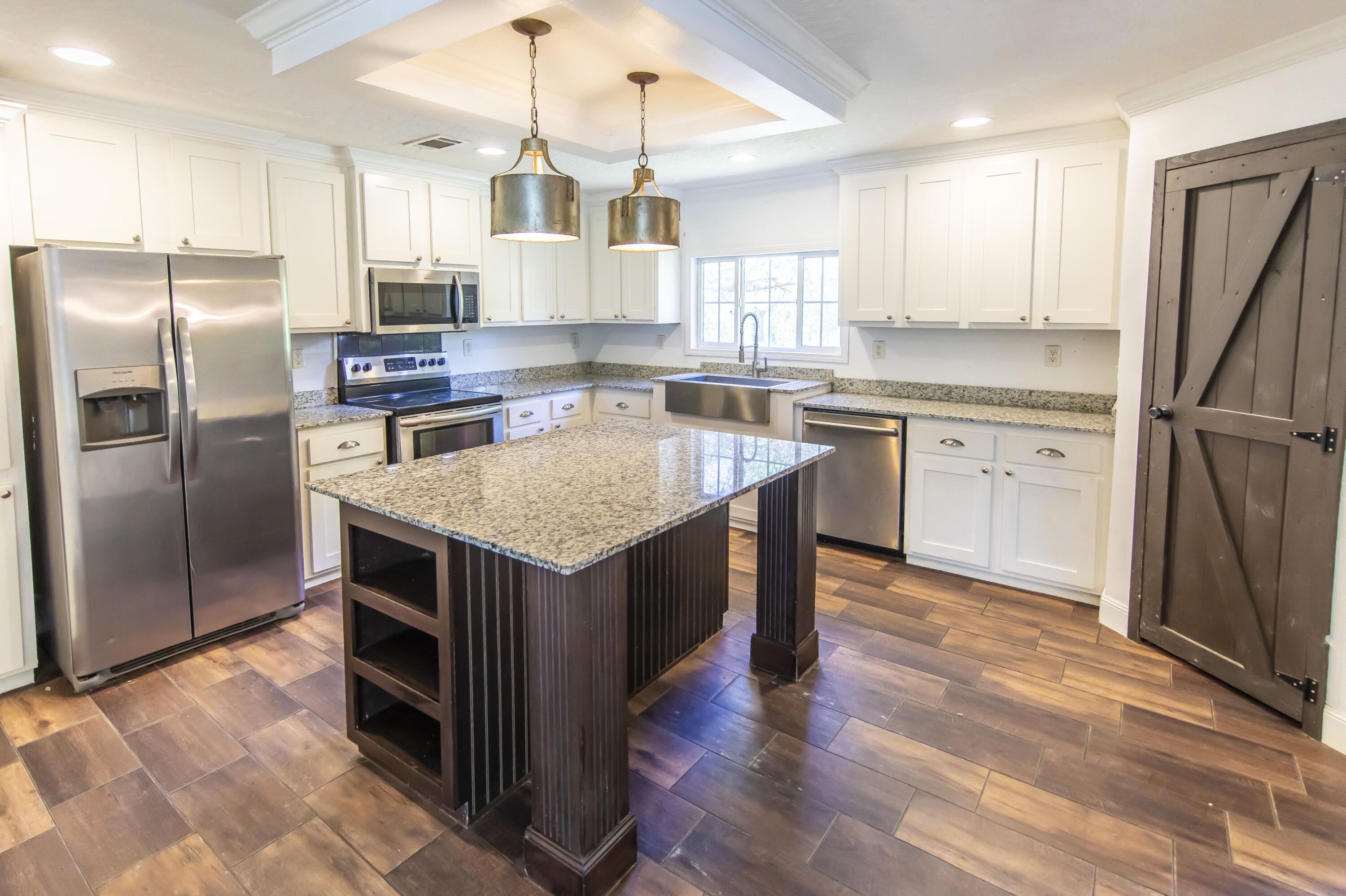 748 Phillips Drive Freeport, FL 32439 - Photo 15 of 50 a kitchen with kitchen island granite countertop a sink stove and refrigerator