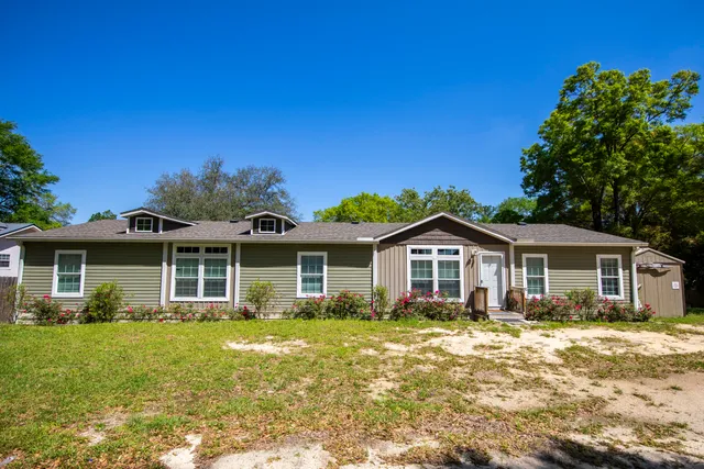 a front view of a house with a garden