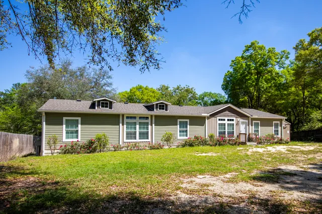 a front view of house with yard and green space