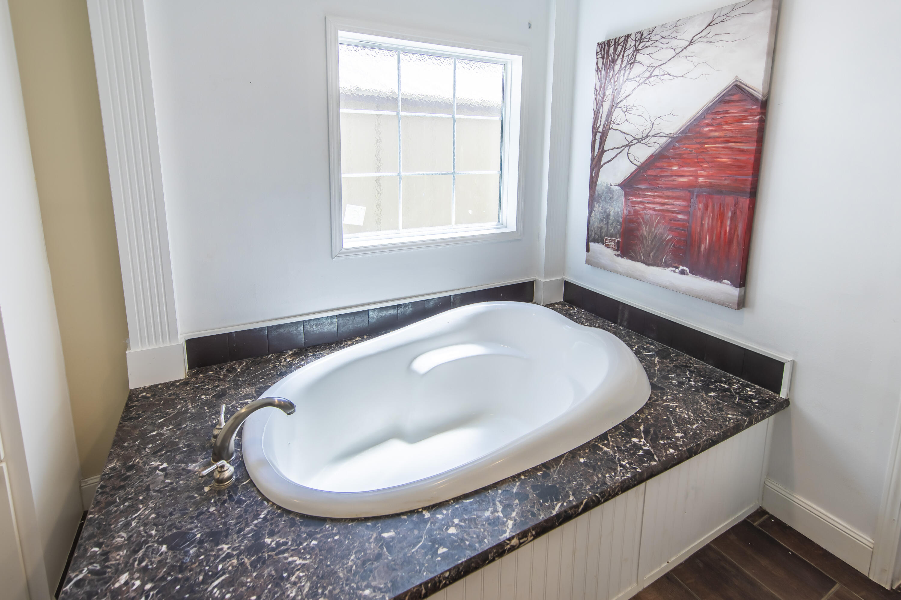 748 Phillips Drive Freeport, FL 32439 - Photo 27 of 50 a bath tub sitting in a bathroom next to a window