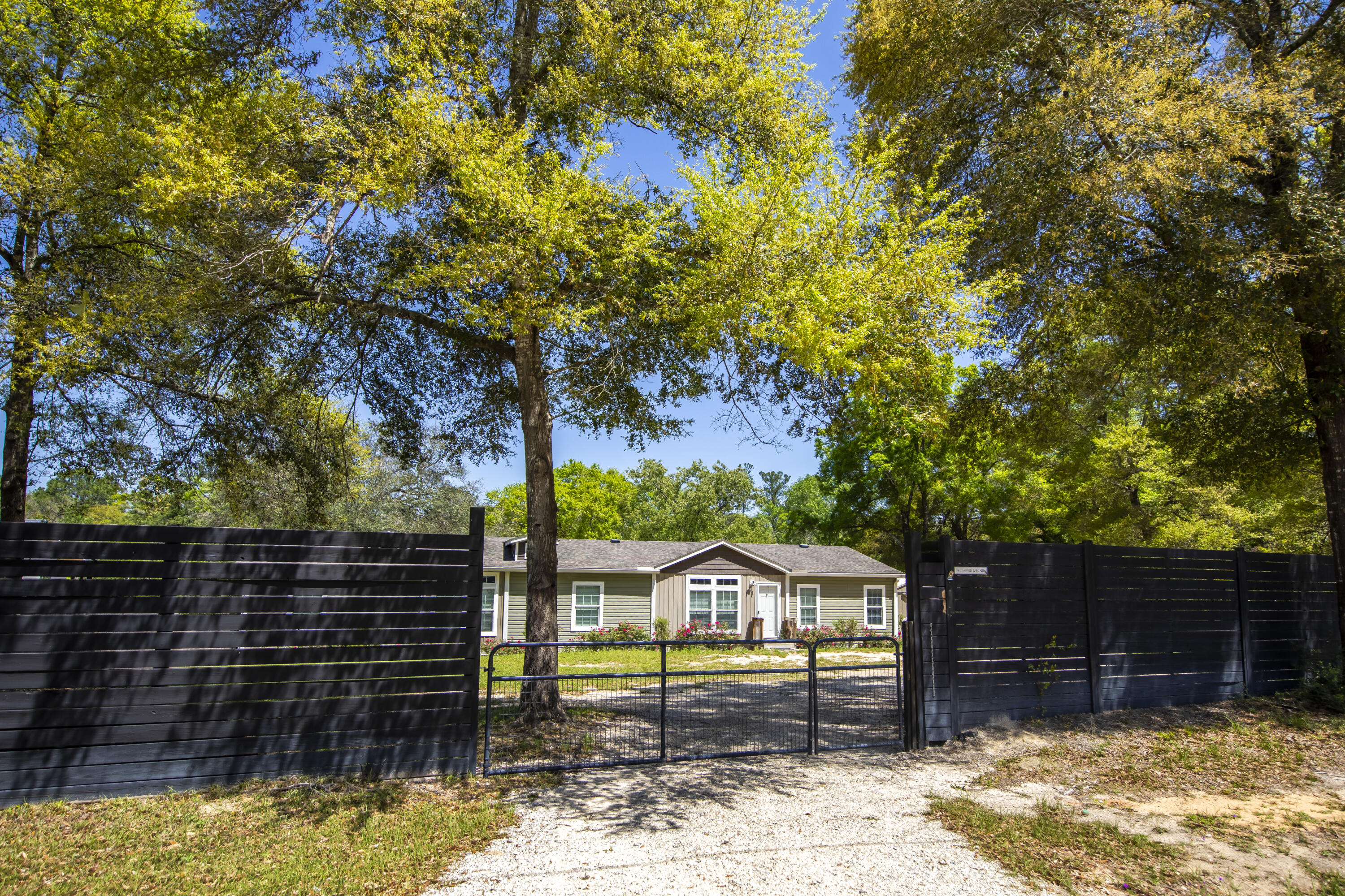 748 Phillips Drive Freeport, FL 32439 - Photo 3 of 50 a front view of a house with a yard