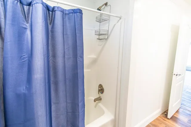 a view of a room with wooden floor