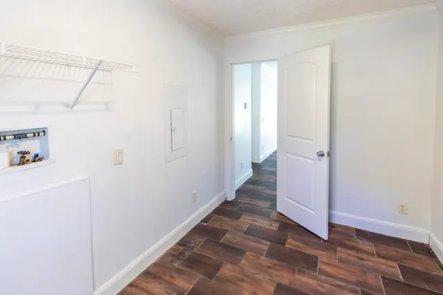 a view of a room with wooden floor and cabinet