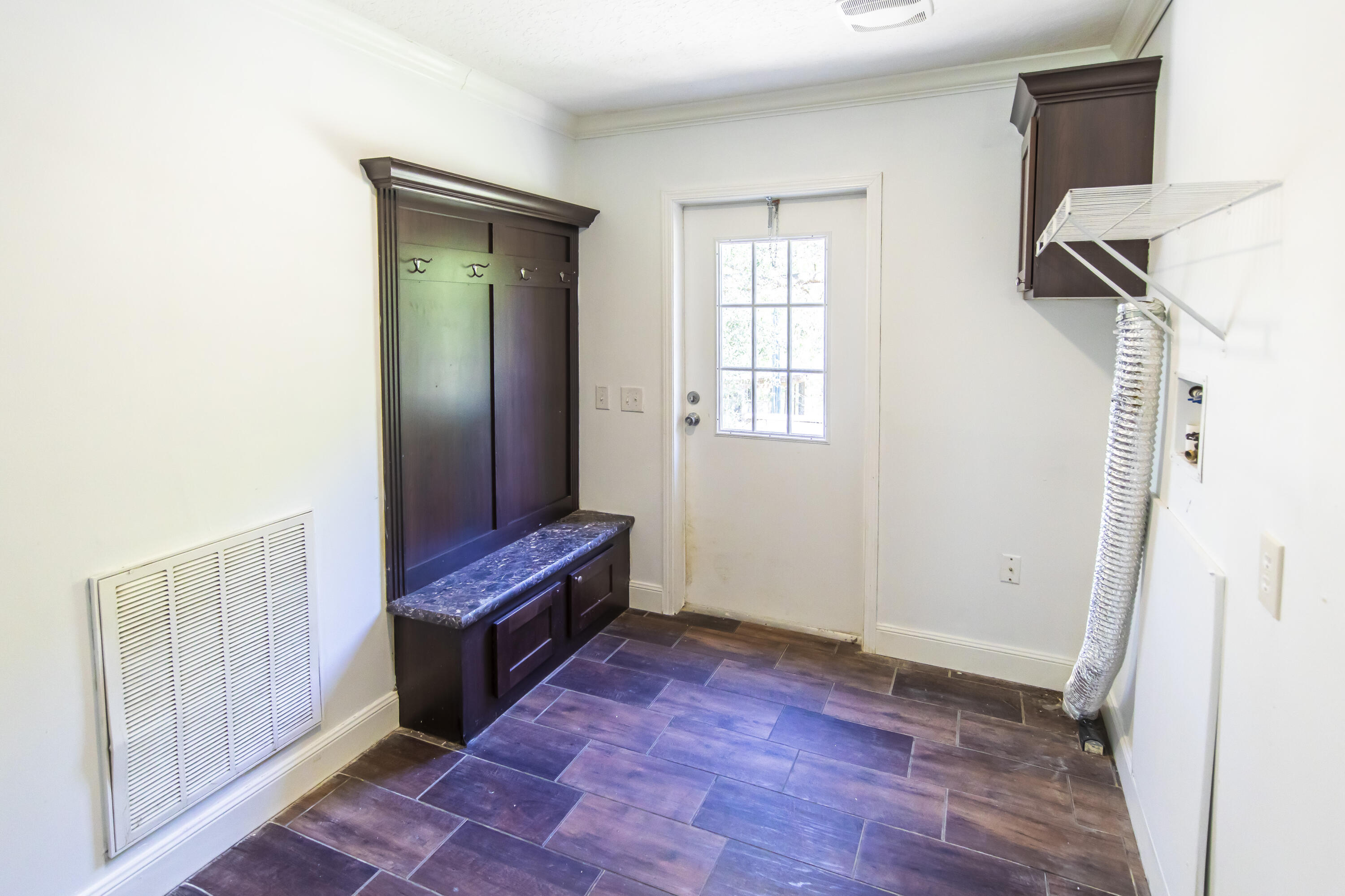 748 Phillips Drive Freeport, FL 32439 - Photo 37 of 50 a view of a room with wooden floor and cabinet