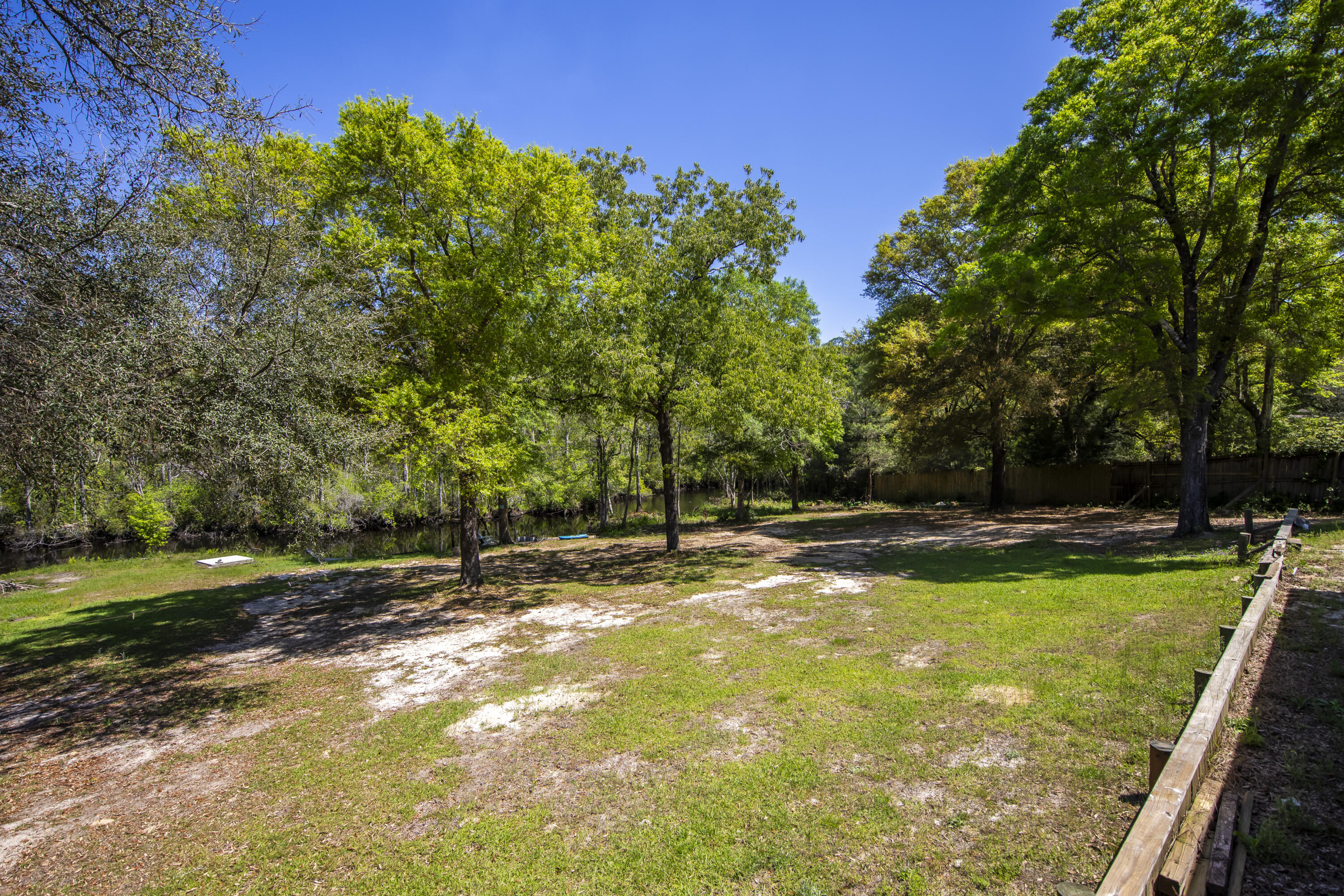 748 Phillips Drive Freeport, FL 32439 - Photo 40 of 50 a view of a swimming pool with a patio and a yard