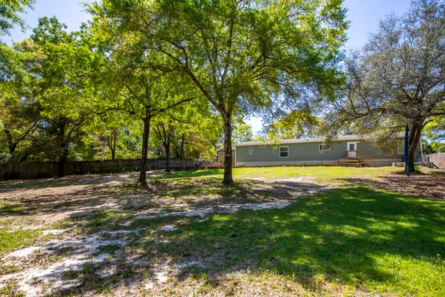 a view of a swimming pool with a yard