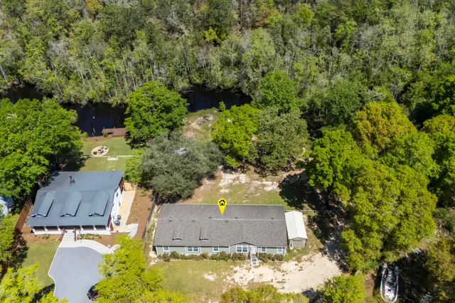 an aerial view of a house with yard swimming pool and outdoor seating