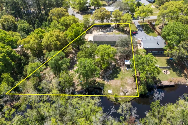an aerial view of a house with a yard and lake view