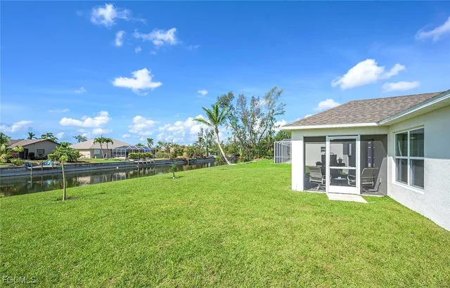 a view of a house with a yard and sitting area