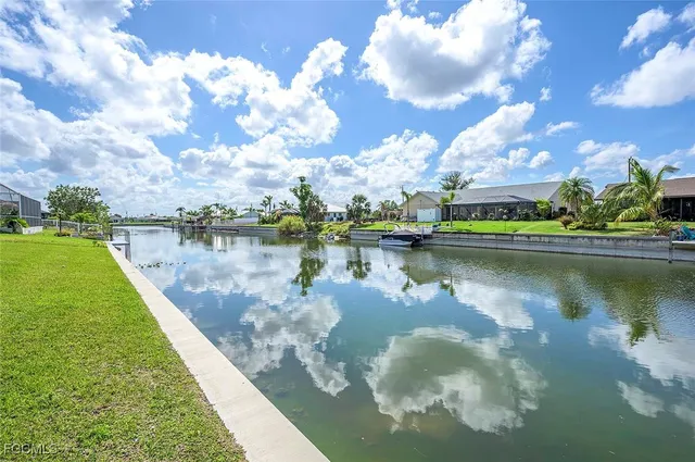 a view of a lake with houses in the back
