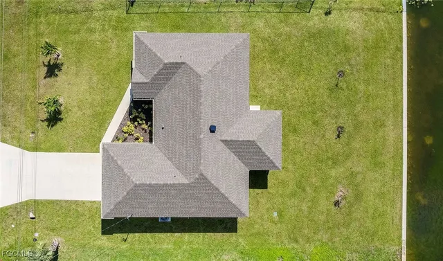an aerial view of a house with a yard