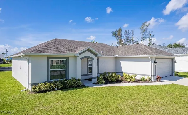 a front view of a house with a yard and garage