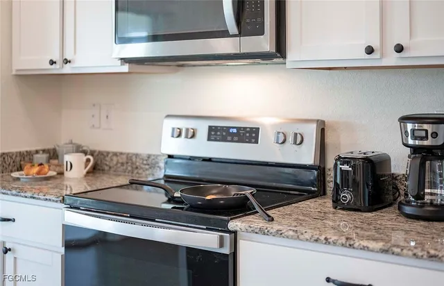 a kitchen with a stove and cabinets
