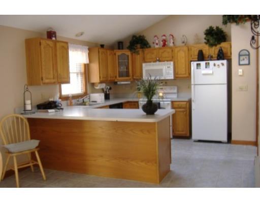 15 Livingston Road Pelham, NH 03076 - Photo 2 of 6 a kitchen with refrigerator and cabinets